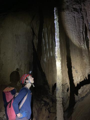 Elizabeth Patterson, UCI Ph.D. candidate in Earth system science, inspects a stalagmite in Hoa Huong Cave in Vietnam’s Phong Nha-Ke Bang National Park.